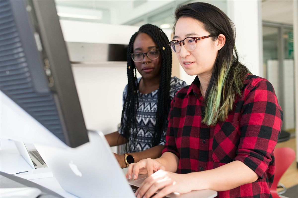 Two colleagues working together at a laptop
