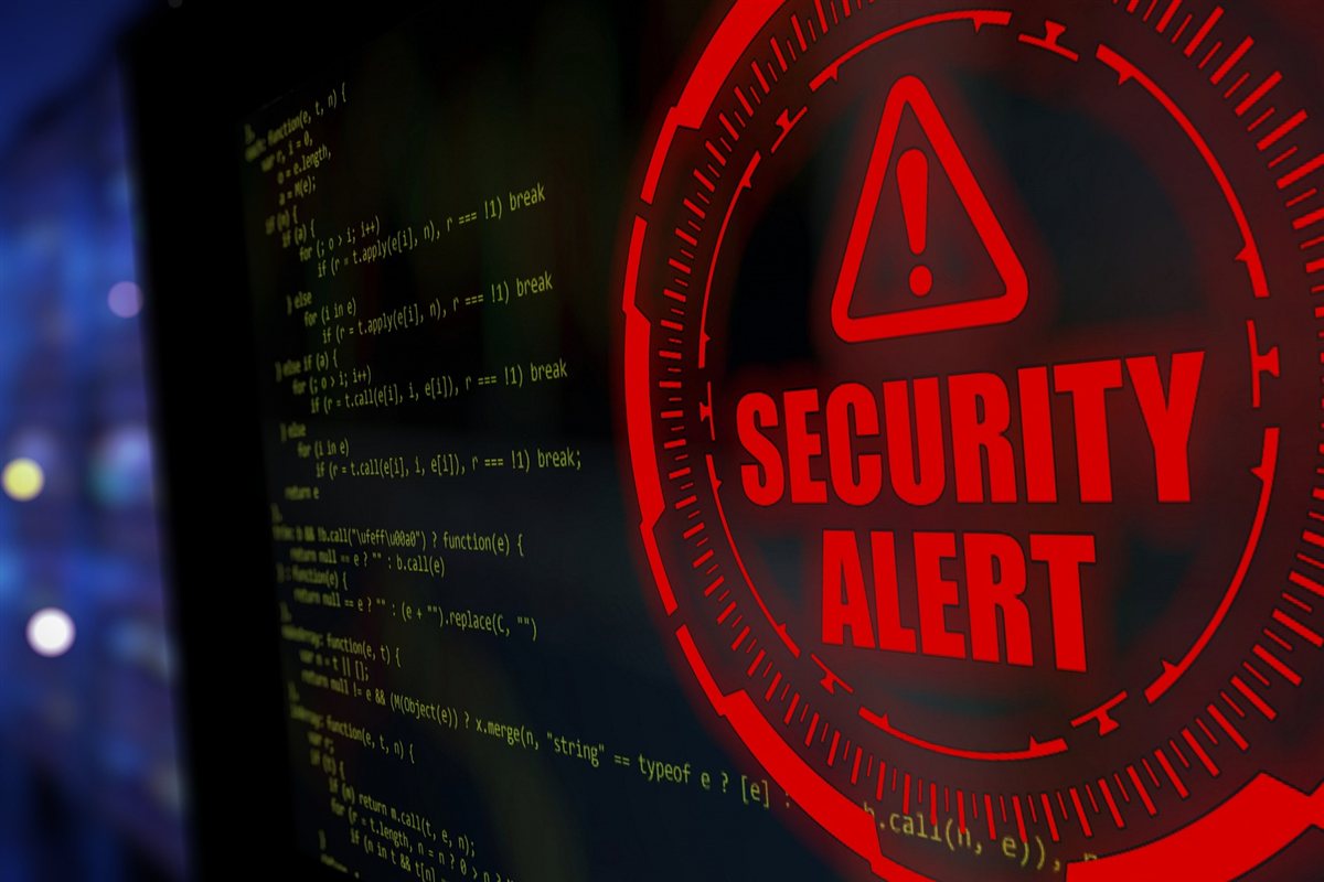 Red security alert warning icon overlaid on a screen showing lines of code