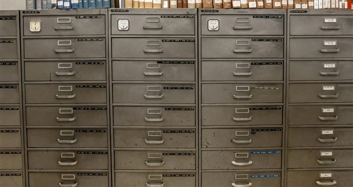 Rows of filing cabinets representing organised, classified records